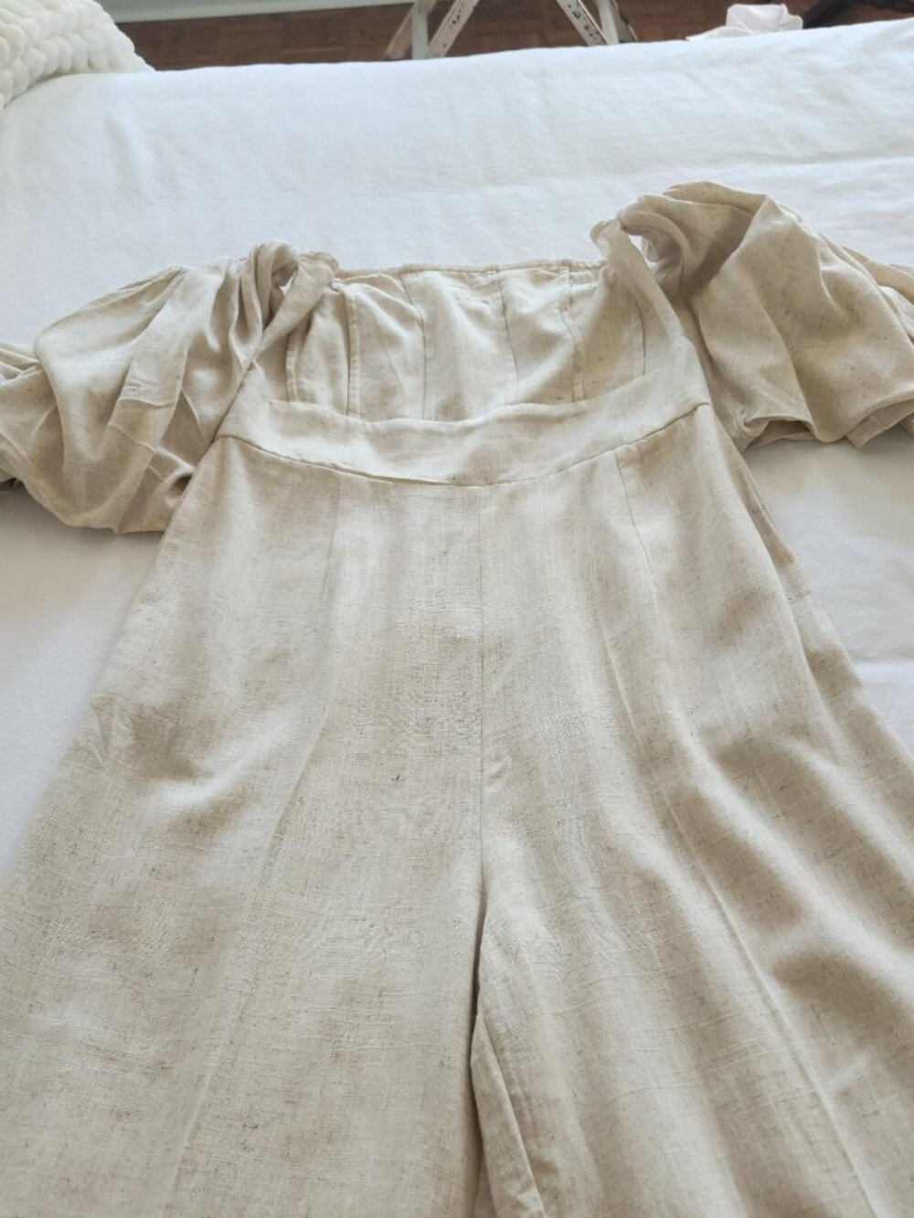 Light beige strapless puff sleeve jumpsuit.